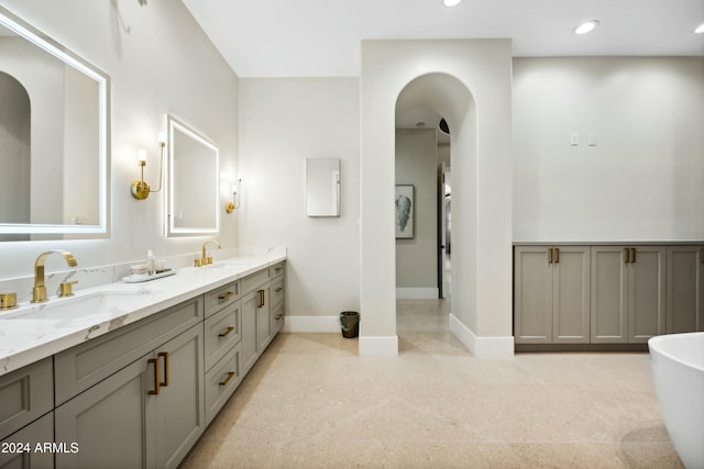 bathroom with a bathing tub and vanity