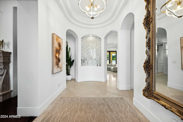 2335 E Plum St, Gilbert, AZ 85298 - corridor with a chandelier, arched walkways, baseboards, and light marble finish floors