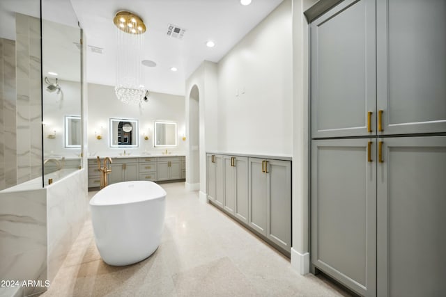 bathroom featuring vanity and independent shower and bath