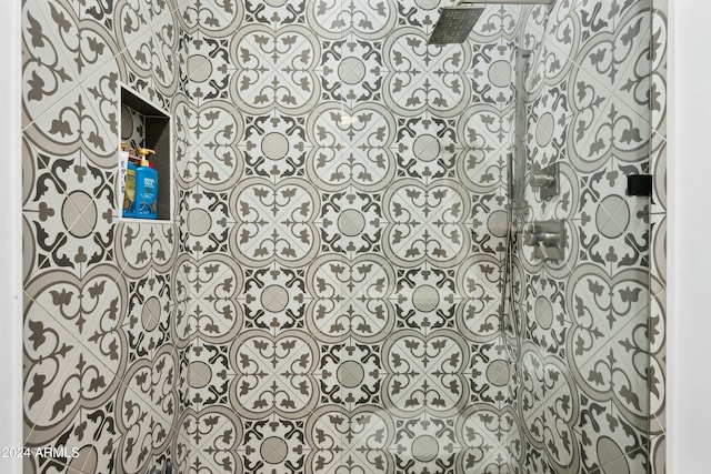 interior details featuring a tile shower