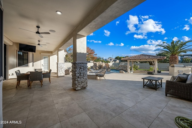 view of patio / terrace with a swimming pool, a gazebo, ceiling fan, pool water feature, and area for grilling