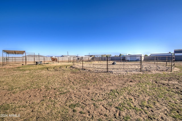 view of yard featuring a rural view and an outdoor structure