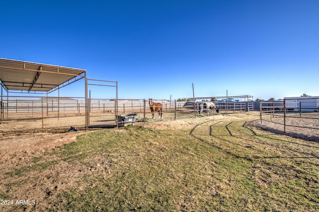 view of yard featuring an outbuilding and a rural view