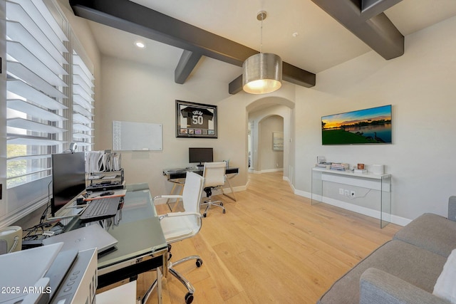 office space featuring light wood finished floors, baseboards, arched walkways, beamed ceiling, and recessed lighting