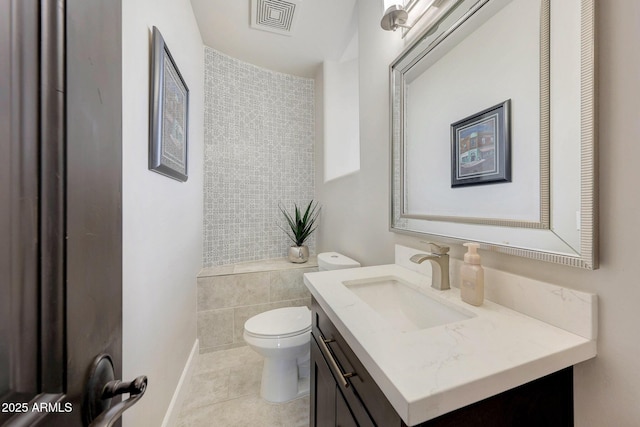 bathroom with visible vents, toilet, vanity, baseboards, and tile patterned floors