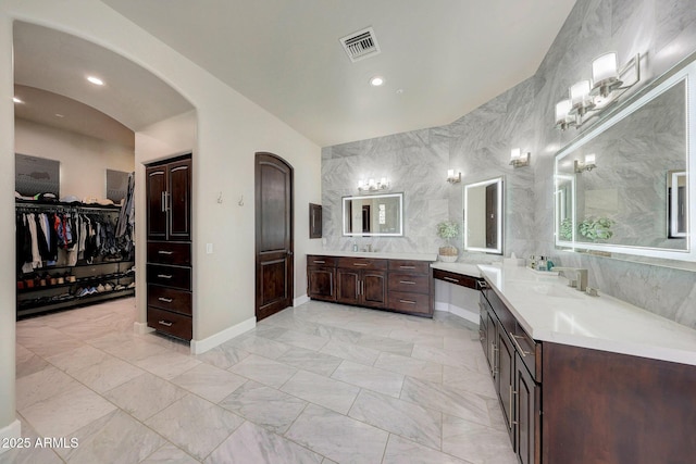 bathroom with recessed lighting, vanity, visible vents, tile walls, and marble finish floor