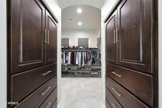 walk in closet featuring arched walkways and visible vents