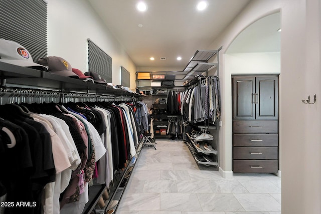 spacious closet with arched walkways