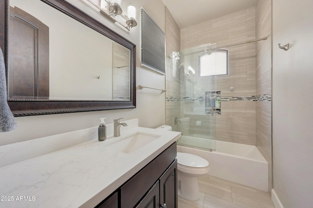 bathroom with toilet, bath / shower combo with glass door, and vanity