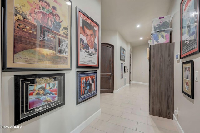 hallway with light tile patterned floors, recessed lighting, and baseboards