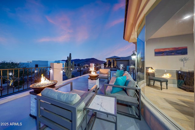 patio terrace at dusk featuring an outdoor fire pit