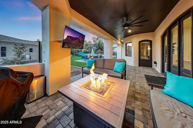 view of patio / terrace featuring an outdoor living space with a fire pit