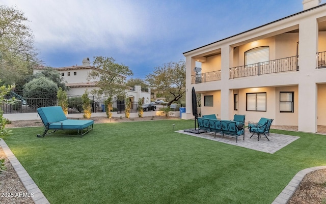 view of yard with a balcony, fence, outdoor lounge area, and a patio