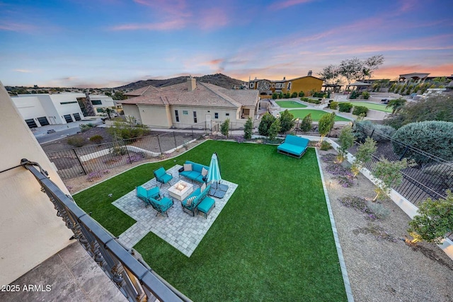 aerial view at dusk featuring a residential view