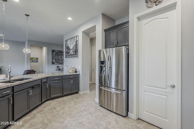 2525 W Balao Dr, Phoenix, AZ 85085 - kitchen with stainless steel fridge with ice dispenser, a sink, light stone countertops, hanging light fixtures, and recessed lighting