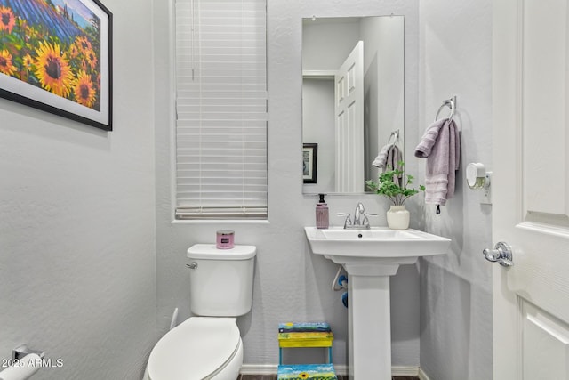 bathroom featuring sink and toilet