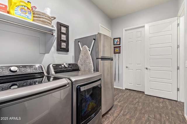 laundry room with dark wood-type flooring and washing machine and clothes dryer