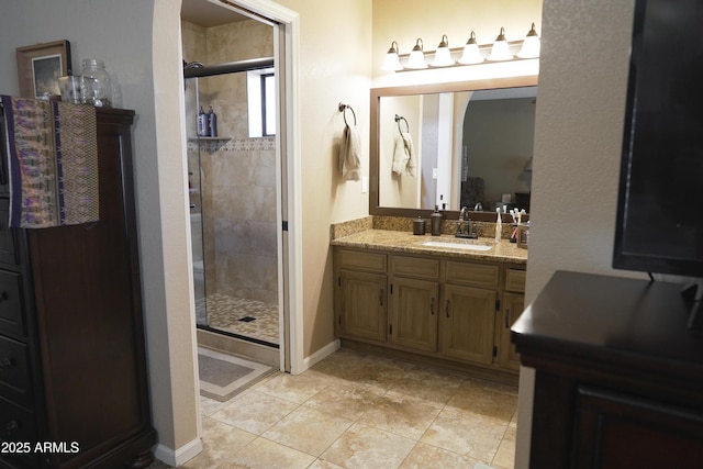 bathroom featuring vanity, a shower with shower door, and tile patterned flooring