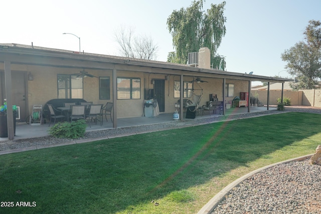 back of house featuring central AC unit, a patio area, ceiling fan, and a lawn