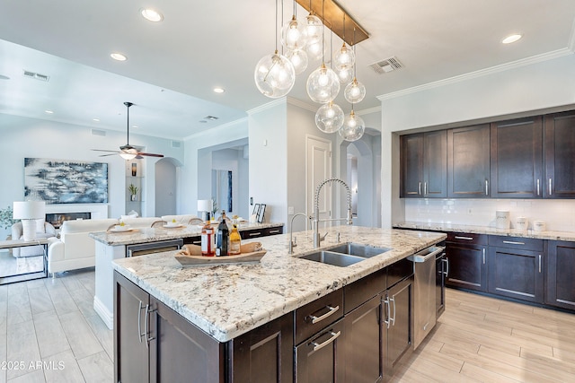 kitchen with arched walkways, a sink, and visible vents