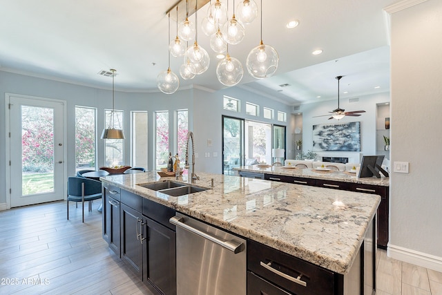 kitchen with visible vents, dishwasher, an island with sink, crown molding, and a sink