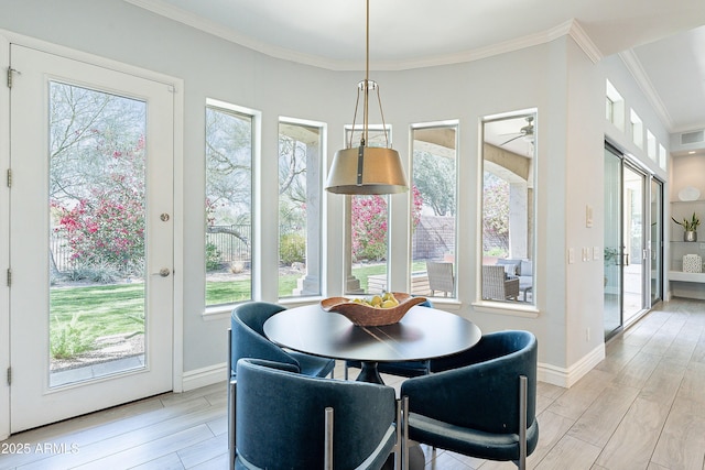 dining area featuring ornamental molding, wood finish floors, and baseboards