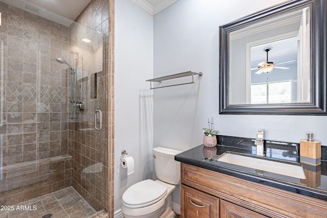 full bath with a stall shower, a ceiling fan, toilet, crown molding, and vanity