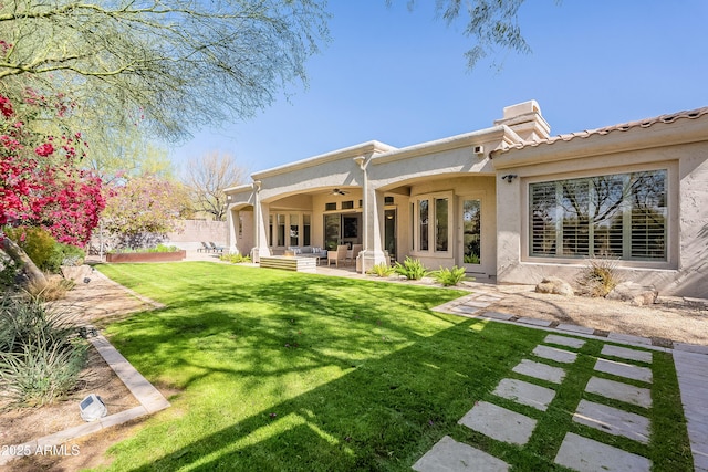 back of house featuring a lawn, ceiling fan, an outdoor hangout area, fence, and a patio area