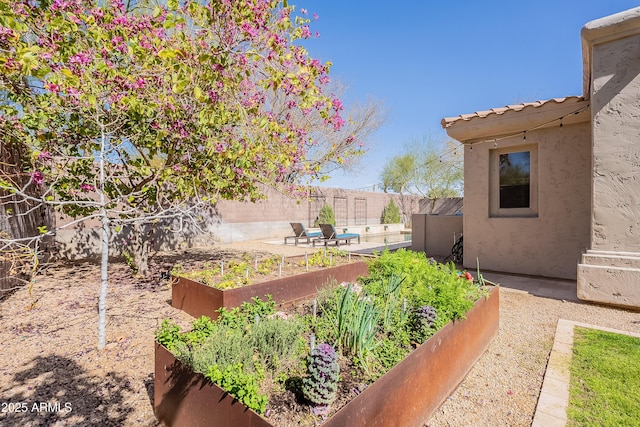 view of yard with a fenced backyard and a garden