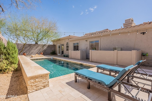 view of swimming pool with a fenced backyard, a fenced in pool, and a patio