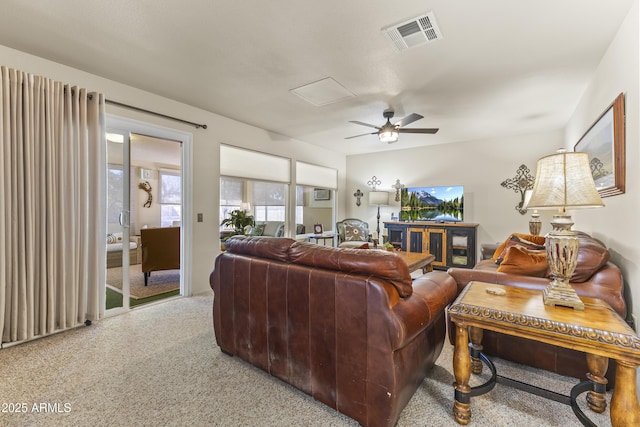 living room with ceiling fan and carpet