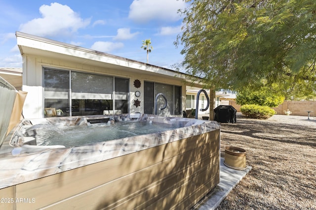 exterior space with a hot tub