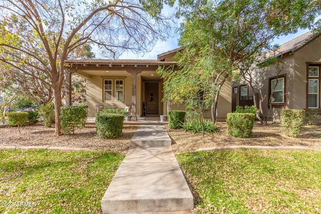 view of front of house with covered porch and a front yard