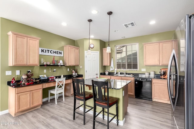 kitchen featuring stainless steel fridge, dishwasher, hanging light fixtures, and light wood-type flooring