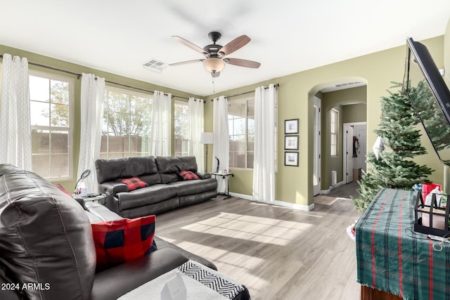 living room featuring a wealth of natural light, ceiling fan, and light hardwood / wood-style floors