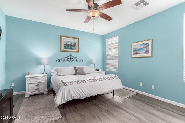 bedroom with hardwood / wood-style floors and ceiling fan