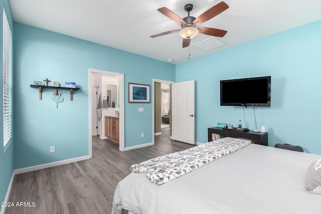 bedroom with ceiling fan, ensuite bathroom, and hardwood / wood-style flooring