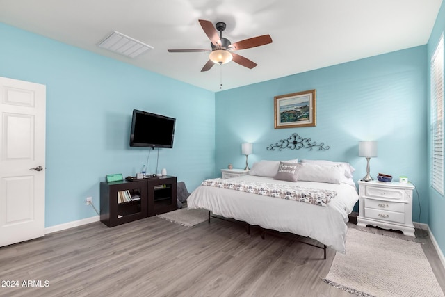 bedroom with ceiling fan and light hardwood / wood-style flooring