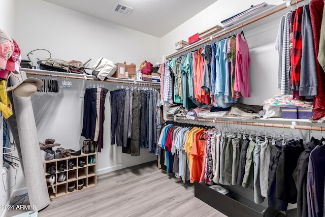 spacious closet featuring light wood-type flooring