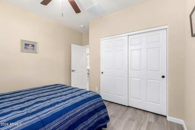 bedroom with ceiling fan, a closet, and light wood-type flooring