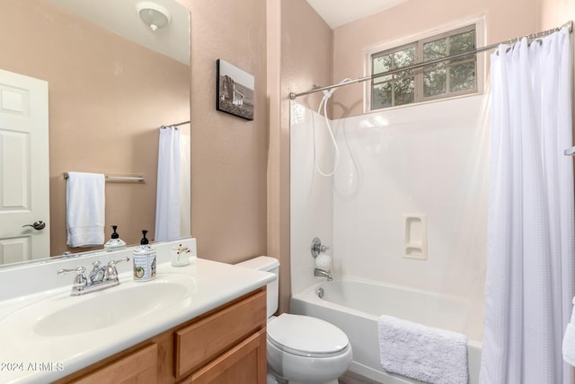 full bathroom featuring shower / bath combo with shower curtain, vanity, and toilet