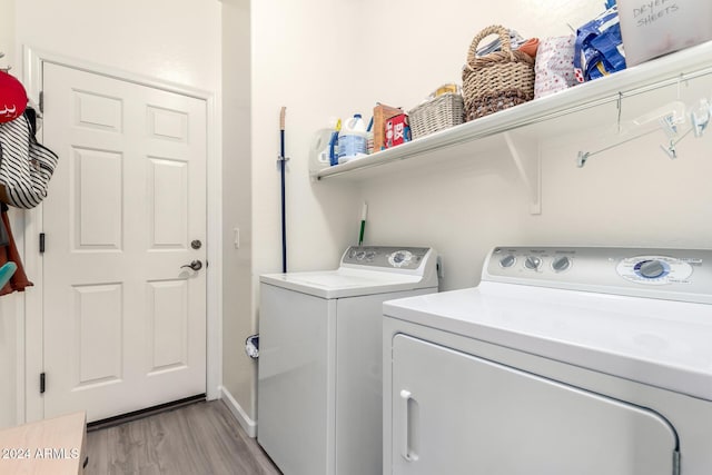 laundry room featuring independent washer and dryer and light wood-type flooring