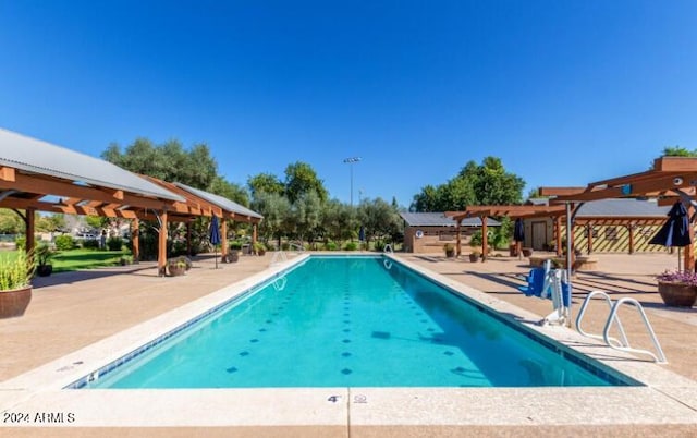 view of pool featuring a pergola and a patio