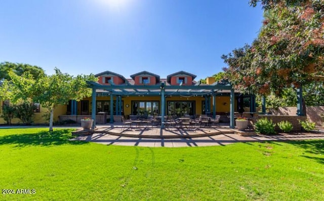 rear view of property with a yard, a patio area, and a pergola