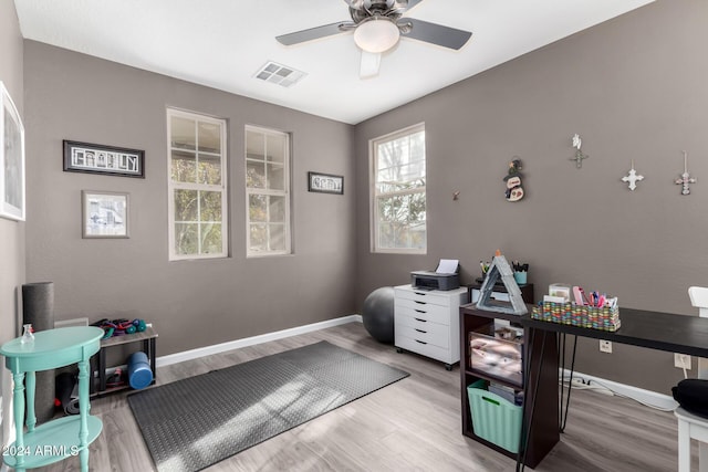 office with hardwood / wood-style flooring and ceiling fan