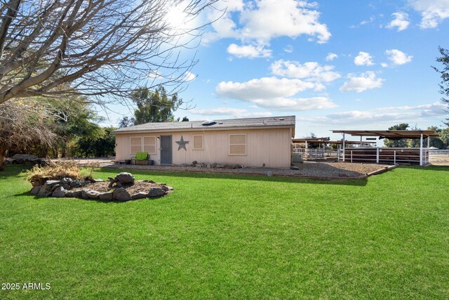 rear view of house featuring a lawn