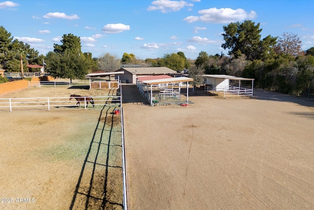 view of playground featuring a rural view and an outdoor structure