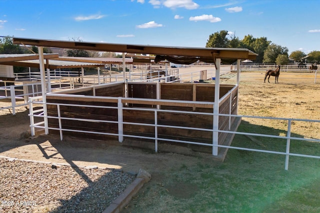 view of horse barn featuring a rural view