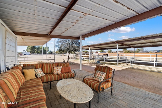 view of patio / terrace featuring a rural view, outdoor lounge area, and an outdoor structure