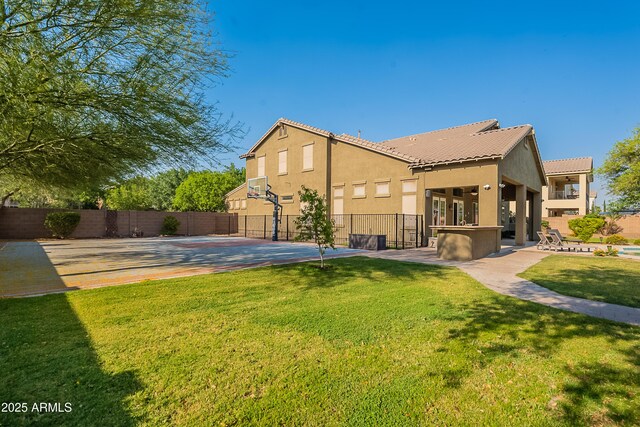 2735 E Flower Ct, Gilbert, AZ 85298 - view of side of property featuring stucco siding, a tiled roof, and basketball court